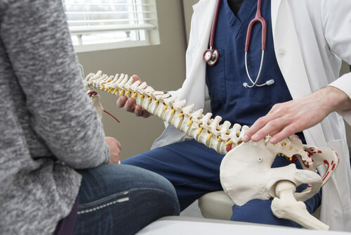 chiropractor examing spinal cord