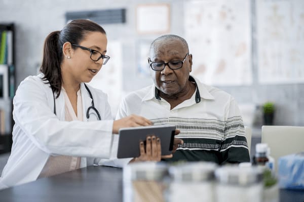 man reviewing information with doctor